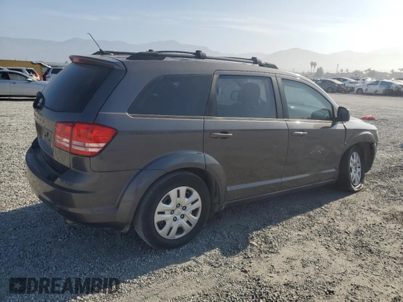 2014 Dodge Journey American Value with VIN 3C4PDCABXET277897, listed as a Copart auction lot 60566735 with 113,343 mi miles and Salvage title. Bid and sale history available at DreamBid. Image 3.
