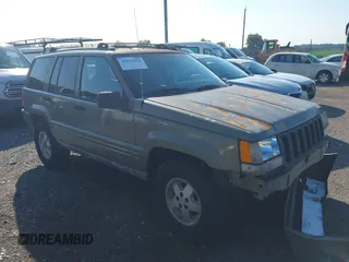 1997 Jeep Grand Cherokee Limited z VIN 1J4GZ78Y5VC613495, wystawiony jako IAAI lot #42823223 z przebiegiem 217 610 mil mil oraz . Historia ofert i sprzedaży dostępna na DreamBid. Obrazek 1.