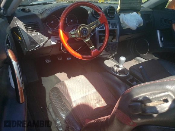 2006 Hyundai Tiburon GT z VIN KMHHN65F66U191134, wystawiony jako Copart lot #56692615 z przebiegiem 197 093 mil mil oraz Szkoda całkowita • Salvage title. Historia ofert i sprzedaży dostępna na DreamBid. Obrazek 8.