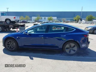 2019 Tesla Model 3 Mid Range with VIN 5YJ3E1EA0KF425079, listed as a IAAI auction lot 41871022 with 61,684 mi miles and . Bid and sale history available at DreamBid. Image 14.