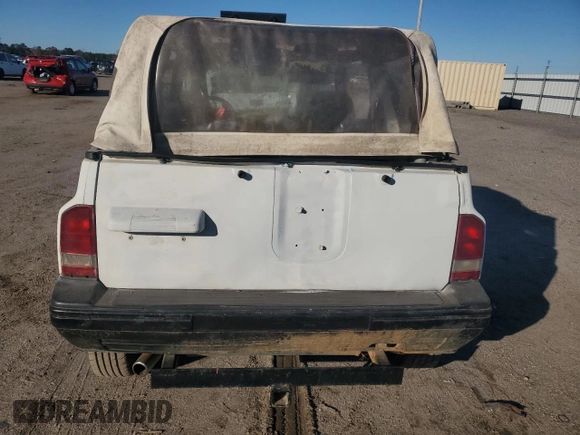 1990 Geo Tracker z VIN 2CNBJ18UXL6217744, wystawiony jako Copart lot #84203244 z przebiegiem 23 221 mil mil oraz Szkody całkowita. Historia ofert i sprzedaży dostępna na DreamBid. Obrazek 6.