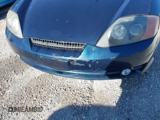 2003 Hyundai Tiburon GT z VIN KMHHN65FX3U076547, wystawiony jako IAAI lot #42015723 z przebiegiem 174 909 mil mil oraz . Historia ofert i sprzedaży dostępna na DreamBid. Obrazek 6.
