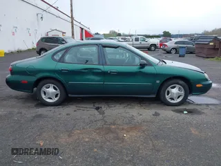 1999 Ford Taurus z VIN 1FAFP52S9XG309250, wystawiony jako IAAI lot #41797222 z przebiegiem 102 676 mil mil oraz . Historia ofert i sprzedaży dostępna na DreamBid. Obrazek 13.