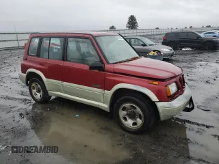 1998 Suzuki Sidekick z VIN JS3TD21VXW4103386, wystawiony jako Copart lot #86219924 z przebiegiem 172 959 mil mil oraz Szkody całkowita. Historia ofert i sprzedaży dostępna na DreamBid. Obrazek 4.