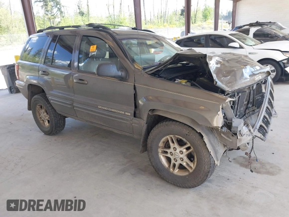 1999 Jeep Grand Cherokee Limited z VIN 1J4GW68N0XC512229, wystawiony jako IAAI lot #42189815 z przebiegiem 230 028 mil mil oraz . Historia ofert i sprzedaży dostępna na DreamBid. Obrazek 1.