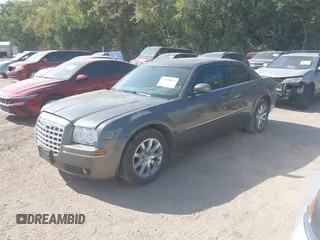 2009 Chrysler 300 Touring with VIN 2C3LA53V09H520923, listed as a IAAI auction lot 40408803 with 216,747 mi miles. Bid and sale history available at carsss.com. Image 2.
