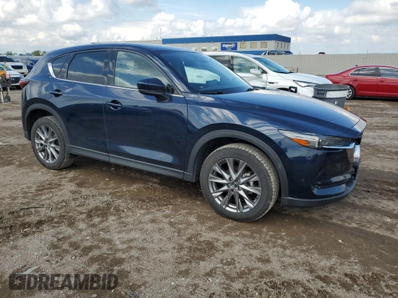 2021 Mazda CX-5 Grand Touring with VIN JM3KFBDM0M0500561, listed as a Copart auction lot 58214665 with 49,543 mi miles and Salvage title. Bid and sale history available at DreamBid. Image 4.