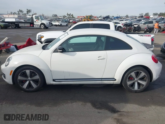 2012 Volkswagen Beetle 2.0T Turbo w/Sun/Snd/Nav PZEV with VIN 3VWVA7ATXCM620731, listed as a IAAI auction lot 41074530 with 99,236 mi miles. Bid and sale history available at carsss.com. Image 14.