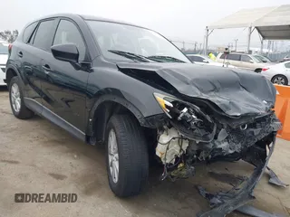 2014 Mazda CX-5 Touring z VIN JM3KE2CY3E0355332, wystawiony jako IAAI lot #42096306 z przebiegiem 108 198 mil mil oraz . Historia ofert i sprzedaży dostępna na DreamBid. Obrazek 1.