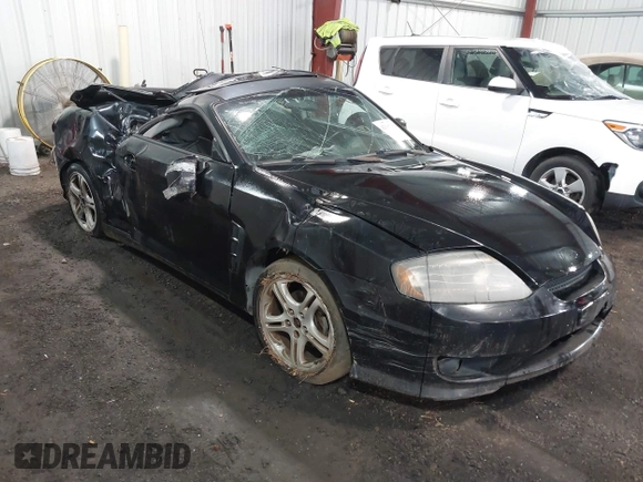 2005 Hyundai Tiburon GT z VIN KMHHN65F45U184777, wystawiony jako IAAI lot #42190342 z przebiegiem 213 013 mil mil oraz . Historia ofert i sprzedaży dostępna na DreamBid. Obrazek 1.
