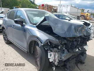 2021 Mazda CX-5 Touring z VIN JM3KFBCM2M0365634, wystawiony jako IAAI lot #42139863 z przebiegiem Nie podano mil oraz . Historia ofert i sprzedaży dostępna na DreamBid. Obrazek 1.
