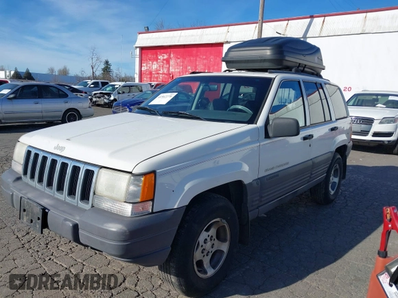 1996 Jeep Grand Cherokee Laredo z VIN 1J4GZ58Y5TC186403, wystawiony jako IAAI lot #41562270 z przebiegiem 205 797 mil mil oraz . Historia ofert i sprzedaży dostępna na DreamBid. Obrazek 2.