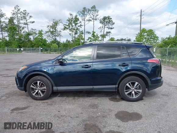 2018 Toyota RAV4 XLE with VIN JTMWFREV9JJ165655, listed as a IAAI auction lot 42138998 with 123,569 mi miles and . Bid and sale history available at carsss.com. Image 14.