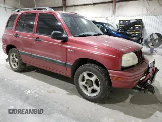 1999 Suzuki Vitara JX z VIN 2S3TD52V4X6110057, wystawiony jako Copart lot #87752215 z przebiegiem 245 419 mil mil oraz Szkody całkowita. Historia ofert i sprzedaży dostępna na DreamBid. Obrazek 4.