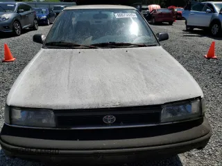 1991 Toyota Corolla z VIN JT2AE94A6M3427211, wystawiony jako Copart lot #60075885 z przebiegiem 179 936 mil mil oraz Czysty tytuł • Clean title. Historia ofert i sprzedaży dostępna na DreamBid. Obrazek 5.