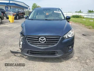 2016 Mazda CX-5 Touring с VIN JM3KE4CY8G0686101, выставлен на аукционе Copart как лот 60361215 с пробегом 126 804 миль миль и На запчасти • Non repairable. История ставок и продаж доступна на DreamBid. Изображение 5.