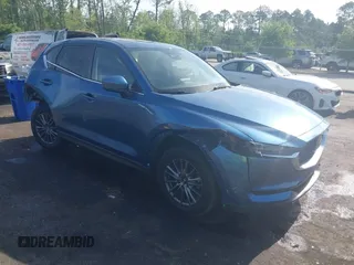 2020 Mazda CX-5 Touring with VIN JM3KFACM5L1854290, listed as a IAAI auction lot 42073191 with 61,487 mi miles. Bid and sale history available at carsss.com. Image 1.