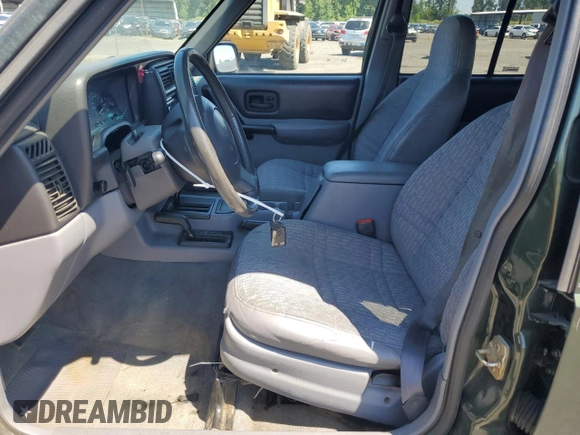 1998 Jeep Cherokee Sport with VIN 1J4FJ68S5WL108020, listed as a Copart auction lot 60150655 with 290,595 mi miles and Salvage title. Bid and sale history available at DreamBid. Image 7.
