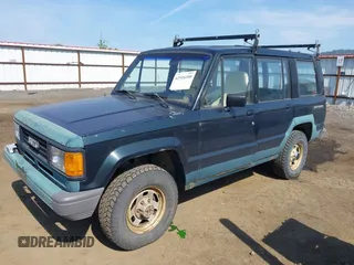 1990 Isuzu Trooper z VIN JACCH58EXL7903060, wystawiony jako IAAI lot #42516100 z przebiegiem 189 700 mil mil oraz . Historia ofert i sprzedaży dostępna na DreamBid. Obrazek 2.