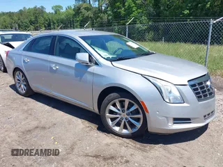 2014 Cadillac XTS Luxury z VIN 2G61M5S31E9199170, wystawiony jako IAAI lot #42150000 z przebiegiem 135 414 mil mil oraz . Historia ofert i sprzedaży dostępna na DreamBid. Obrazek 1.
