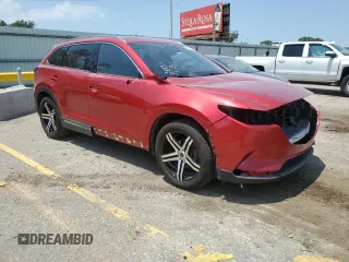 2016 Mazda CX-9 Grand Touring with VIN JM3TCADY6G0105783, listed as a Copart auction lot 63975195 with 135,972 mi miles and Salvage title. Bid and sale history available at DreamBid. Image 4.