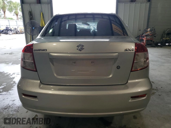 2012 Suzuki SX4 LE z VIN JS2YC5A34C6304150, wystawiony jako Copart lot #48629255 z przebiegiem 104 658 mil mil oraz Szkoda całkowita • Salvage title. Historia ofert i sprzedaży dostępna na DreamBid. Obrazek 6.