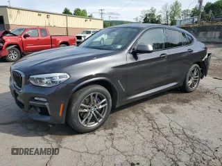 2019 BMW X4 M40i with VIN 5UXUJ5C58KLJ64003, listed as a Copart auction lot 57304575 with 90,596 mi miles and Salvage title. Bid and sale history available at DreamBid. Image 1.