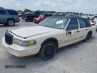 1997 Lincoln Town Car Cartier with VIN 1LNLM83W8VY627663, listed as a IAAI auction lot 42392454 with 209,440 mi miles and . Bid and sale history available at DreamBid. Image 2.