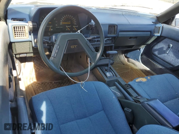 1983 Toyota Celica z VIN JT2RA64L7D6174381, wystawiony jako Copart lot #75986554 z przebiegiem 312 583 mil mil oraz Szkoda całkowita • Salvage title. Historia ofert i sprzedaży dostępna na DreamBid. Obrazek 8.