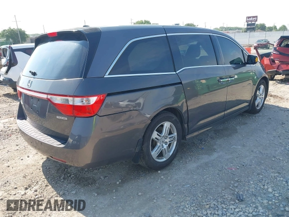 2013 Honda Odyssey Touring with VIN 5FNRL5H98DB080296, listed as a IAAI auction lot 42461843 with 104,901 mi miles and . Bid and sale history available at DreamBid. Image 4.
