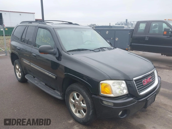 2002 GMC Envoy SLT with VIN 1GKDT13S222143135, listed as a IAAI auction lot 42136672 with 206,064 mi miles. Bid and sale history available at carsss.com. Image 1.