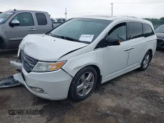 2012 Honda Odyssey Touring with VIN 5FNRL5H93CB034485, listed as a IAAI auction lot 42304502 with 198,589 mi miles and . Bid and sale history available at DreamBid. Image 2.