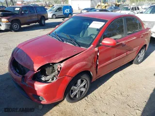2010 Kia Rio LX with VIN KNADH4A34A6612529, listed as a IAAI auction lot 41859726 with 199,580 mi miles. Bid and sale history available at carsss.com. Image 2.