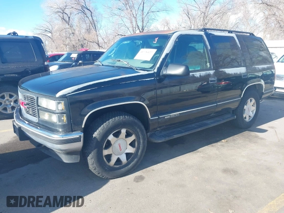 1997 GMC Yukon with VIN 1GKEK13R3VJ759103, listed as a IAAI auction lot 41726127 with 218,500 mi miles. Bid and sale history available at carsss.com. Image 2.