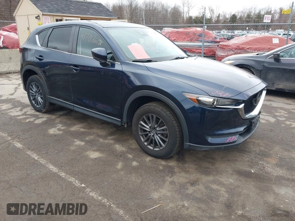 2021 Mazda CX-5 Touring with VIN JM3KFBCM7M1380396, listed as a IAAI auction lot 41707612 with 55,555 mi miles. Bid and sale history available at carsss.com. Image 1.