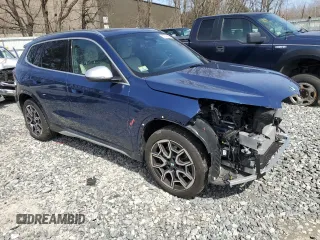 2023 BMW X1 xDrive28i with VIN WBX73EF05P5Y21721, listed as a Copart auction lot 50749295 with 10,633 mi miles and Salvage title. Bid and sale history available at DreamBid. Image 4.