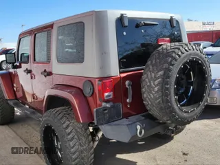 2010 Jeep Wrangler Unlimited Sahara with VIN 1J4BA5H10AL117474, listed as a IAAI auction lot 41969202 with 131,256 mi miles. Bid and sale history available at carsss.com. Image 3.