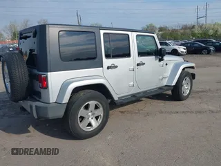 2009 Jeep Wrangler Unlimited Sahara with VIN 1J4GA59129L780013, listed as a IAAI auction lot 41976308 with 164,738 mi miles. Bid and sale history available at carsss.com. Image 4.