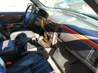 1999 Jeep Grand Cherokee Limited with VIN 1J4GW68N8XC770305, listed as a IAAI auction lot 41720558 with 206,180 mi miles. Bid and sale history available at carsss.com. Image 5.