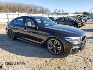 2020 BMW 5 Series M550i xDrive with VIN WBAJS7C0XLCE44248, listed as a Copart auction lot 48660045 with 73,949 mi miles and Salvage title. Bid and sale history available at DreamBid. Image 4.