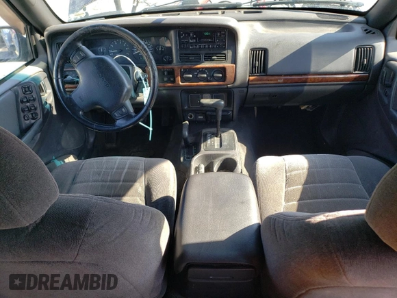 1998 Jeep Grand Cherokee Laredo with VIN 1J4GZ58S8WC167716, listed as a Copart auction lot 76477694 with 167,519 mi miles and Salvage Title. Bid and sale history available at carsss.com. Image 8.