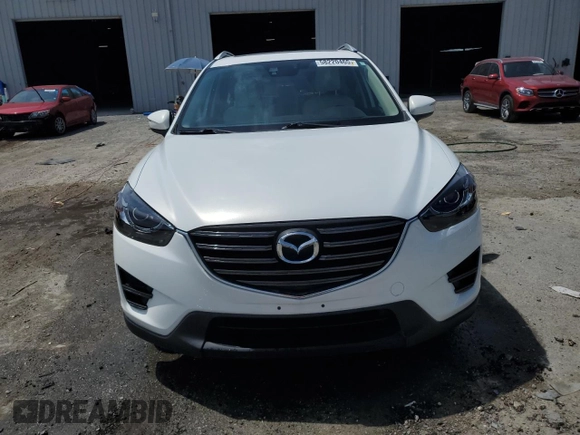 2016 Mazda CX-5 Grand Touring z VIN JM3KE2DYXG0731462, wystawiony jako Copart lot #58220465 z przebiegiem 130 033 mil mil oraz Szkoda całkowita • Salvage title. Historia ofert i sprzedaży dostępna na DreamBid. Obrazek 5.