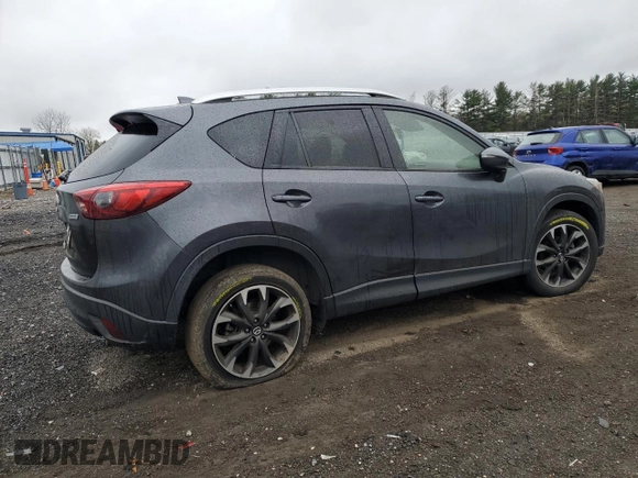 2016 Mazda CX-5 Grand Touring z VIN JM3KE2DY9G0687261, wystawiony jako Copart lot #52865415 z przebiegiem Nie podano mil oraz Szkoda całkowita • Salvage title. Historia ofert i sprzedaży dostępna na DreamBid. Obrazek 3.