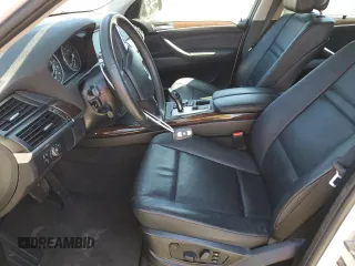 2012 BMW X5 35i with VIN 5UXZV4C5XCL987618, listed as a Copart auction lot 60308965 with 98,195 mi miles and Salvage title. Bid and sale history available at DreamBid. Image 7.