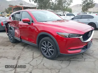 2018 Mazda CX-5 Grand Touring z VIN JM3KFADMXJ0302656, wystawiony jako IAAI lot #42099173 z przebiegiem 125 378 mil mil oraz . Historia ofert i sprzedaży dostępna na DreamBid. Obrazek 1.