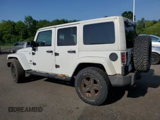 2013 Jeep Wrangler Unlimited Sport z VIN 1C4HJWDG9DL581643, wystawiony jako Copart lot #60775805 z przebiegiem 148 959 mil mil oraz Czysty tytuł • Clean title. Historia ofert i sprzedaży dostępna na DreamBid. Obrazek 2.