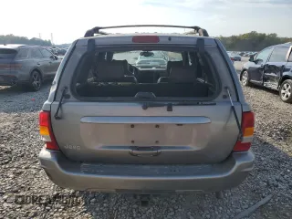 1999 Jeep Grand Cherokee Limited with VIN 1J4G268S7XC668348, listed as a Copart auction lot 77824084 with 165,779 mi miles and Salvage title. Bid and sale history available at DreamBid. Image 6.