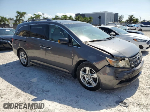 2011 Honda Odyssey Touring with VIN 5FNRL5H97BB501213, listed as a Copart auction lot 57314115 with 283,538 mi miles and Salvage title. Bid and sale history available at DreamBid. Image 4.
