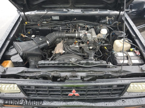 1991 Mitsubishi Mighty Max z VIN JA7FL25W7MP028365, wystawiony jako Copart lot #43964285 z przebiegiem 175 102 mil mil oraz Szkody całkowita. Historia ofert i sprzedaży dostępna na DreamBid. Obrazek 11.