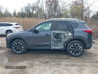 2016 Mazda CX-5 Grand Touring with VIN JM3KE4DYXG0830150, listed as a IAAI auction lot 41961007 with 142,570 mi miles and . Bid and sale history available at DreamBid. Image 14.